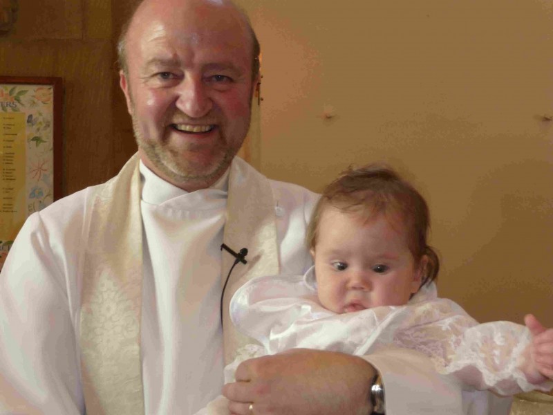 Vicar baptising baby